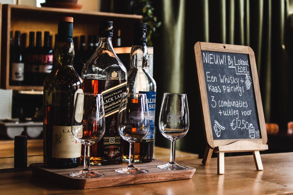 wine bottles and wine glasses on brown surface