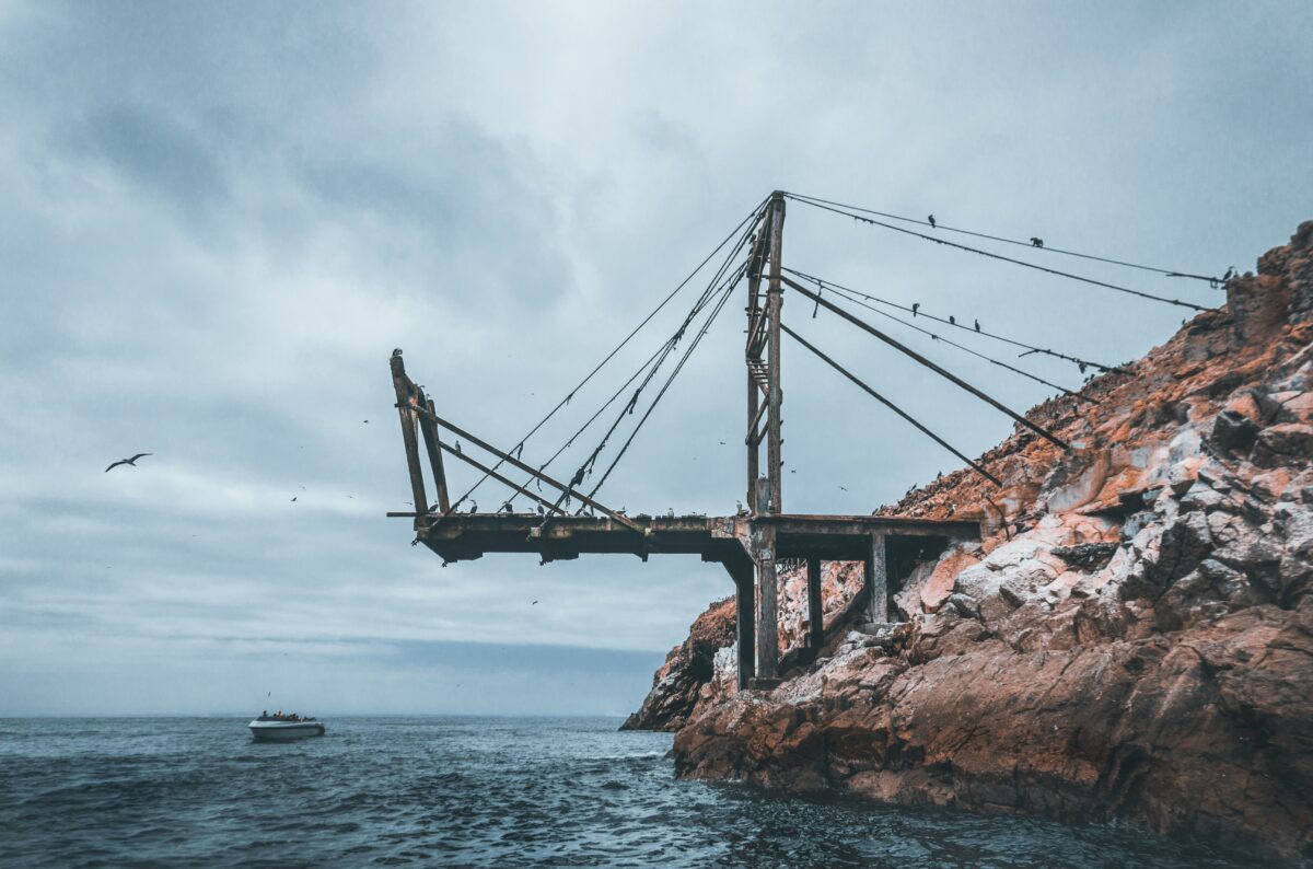 metal bridge near boat during daytime